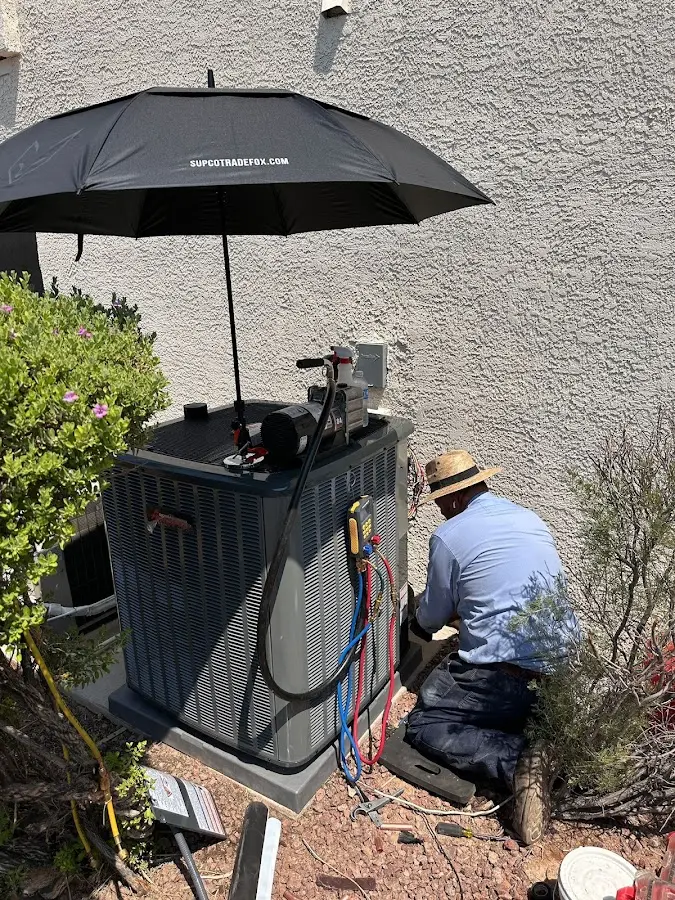 HVAC technician performing outdoor AC maintenance in Waynesboro